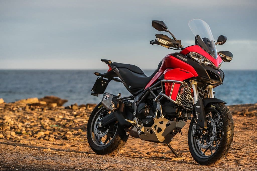 2017-2020 Ducati Multistrada 950 - red, parked in front of ocean