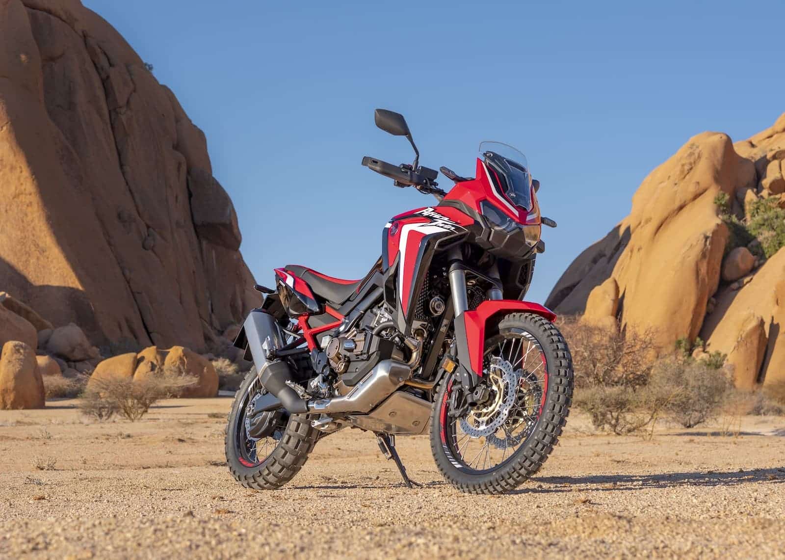 red and black Honda Africa Twin CRF1100L against rocks and blue sky
