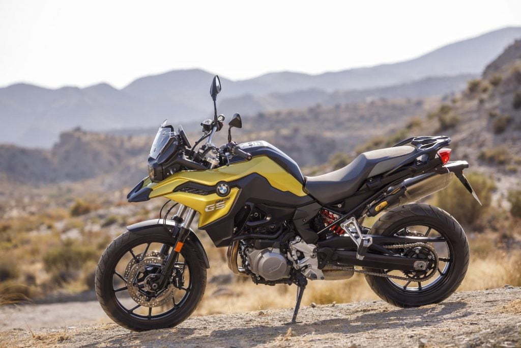gold BMW F 750 GS outdoors on dirt road