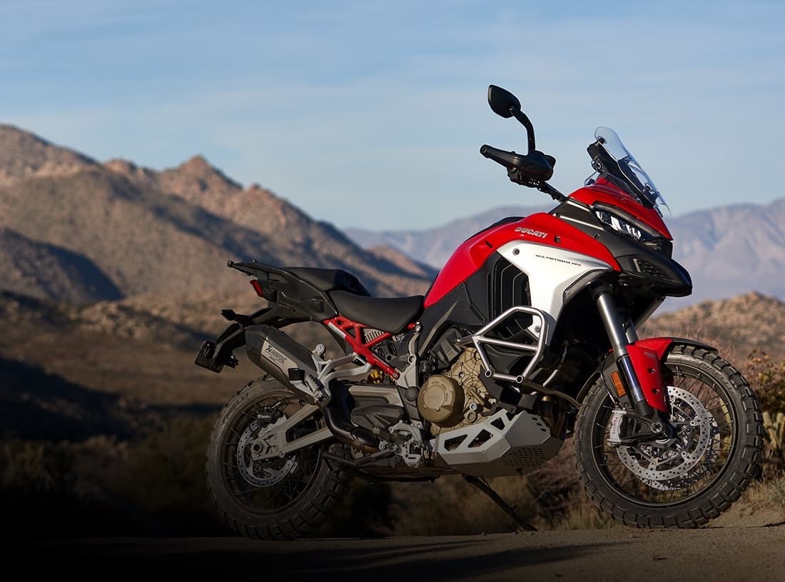 Ducati Multistrada V4S red akrapovic exhaust RHS in front of mountains