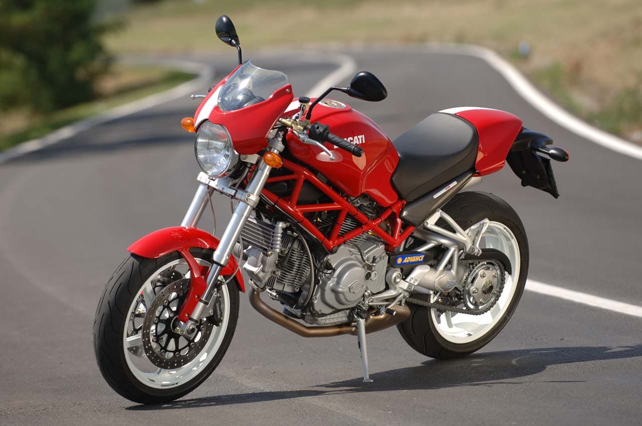 Red Ducati Monster S2R1000 on winding road LHS