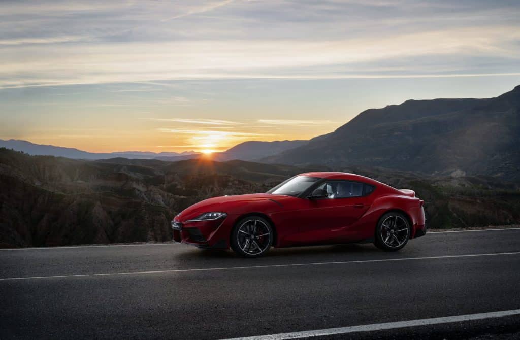 Toyota GR Supra driving at sunset